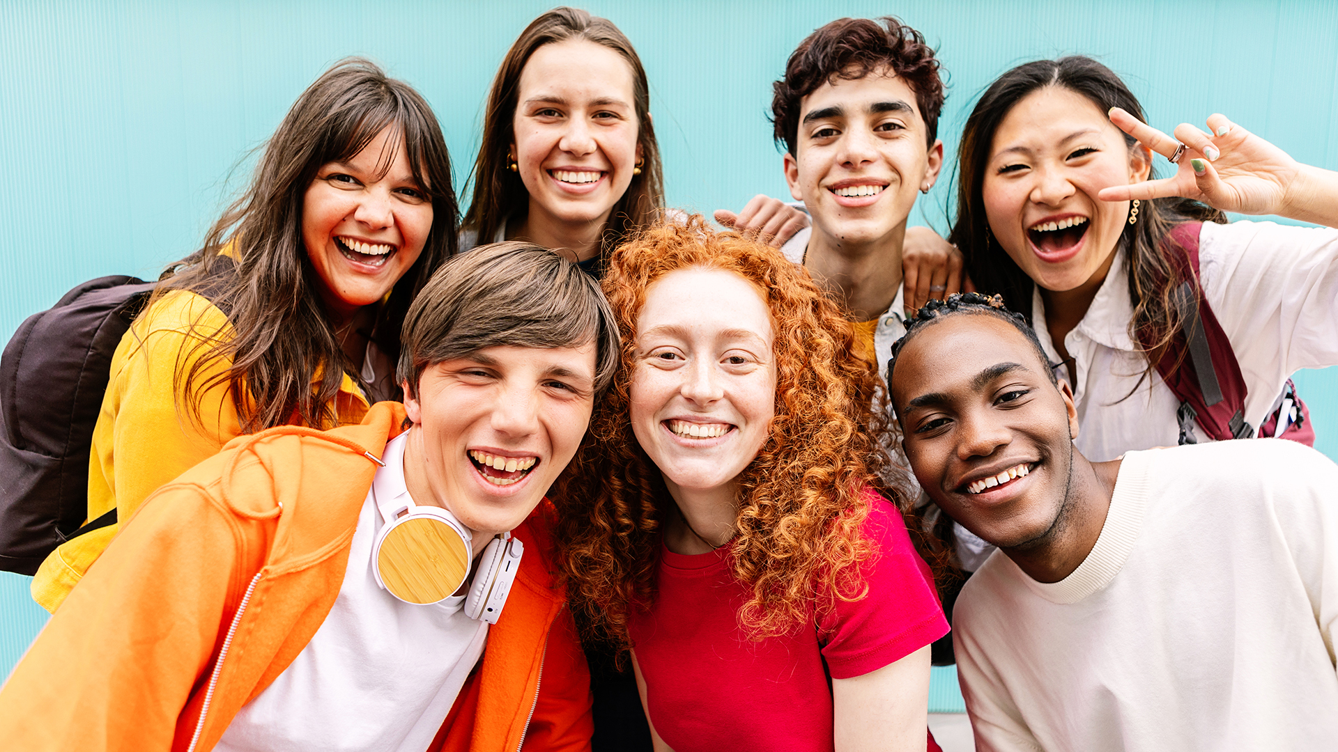 Image of a diverse group of teenage student friends standing