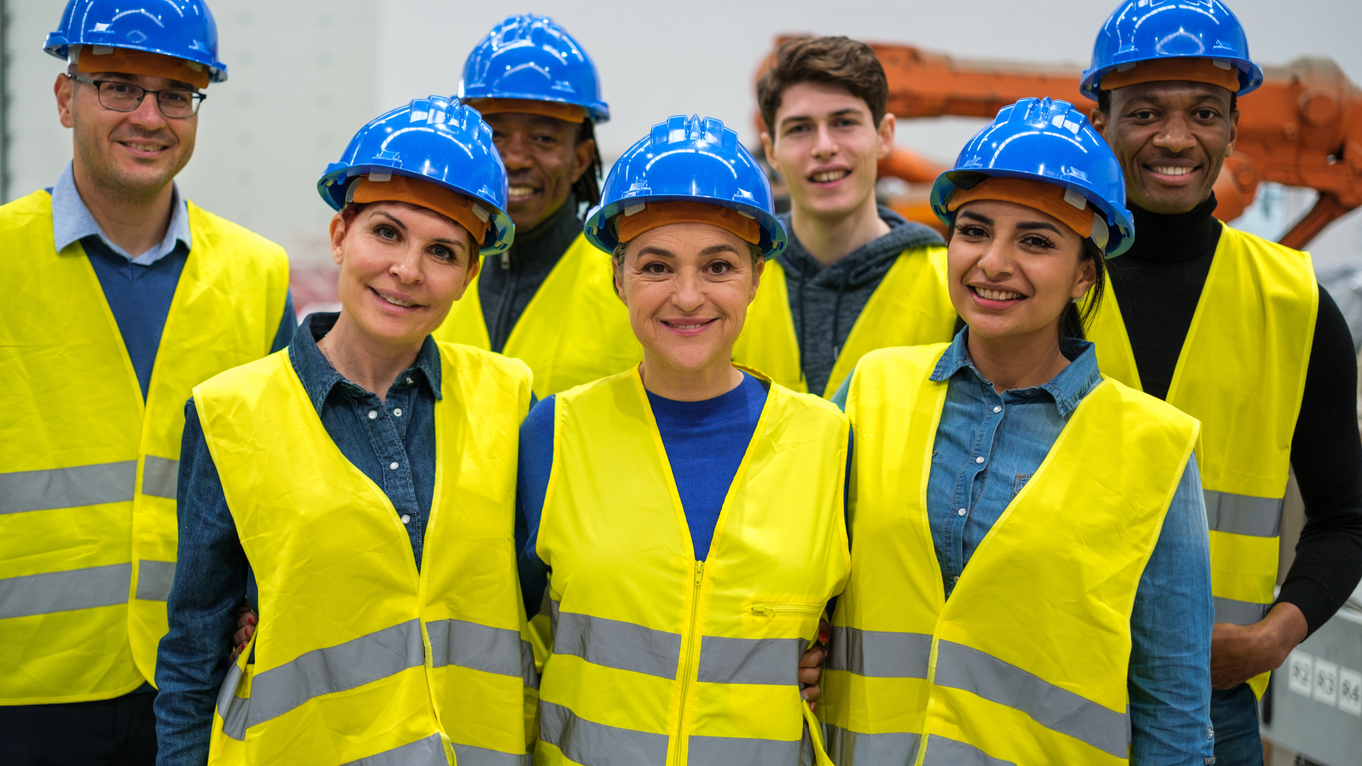 Staff stood wearing a hard hats and hi-vis