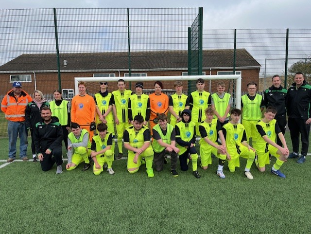 Image of the footy team and coaches