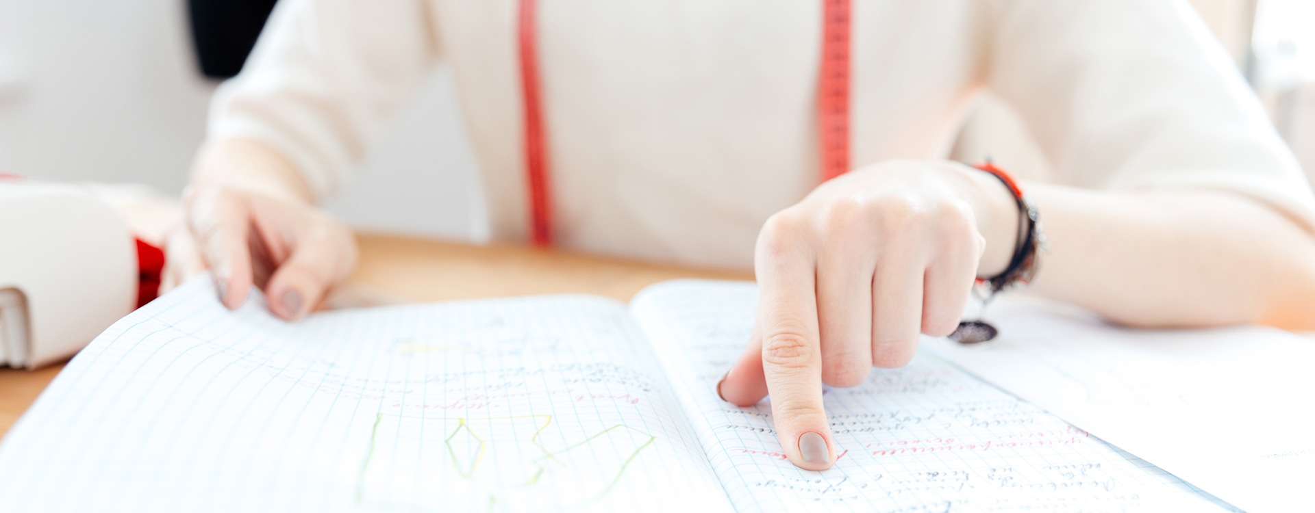 Image of a young woman pointing and reading notes